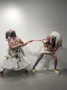 Doll dress and clown playing tug a war